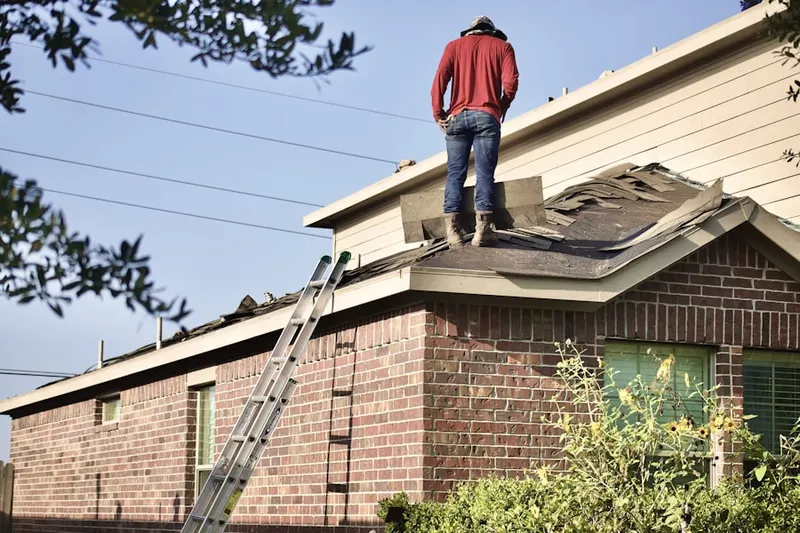Professional roofer working on a residential roof in Shakertown
